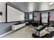 Cozy media room with reclining chairs, a projector screen, and custom decor for immersive entertainment at 2933 Fable St, Kissimmee, FL 34746