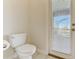 A simple, but clean, toilet room with exterior door to backyard and bright natural light at 2933 Fable St, Kissimmee, FL 34746