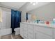 Well-lit bathroom with a double vanity, white cabinetry, and a shower-tub combo at 3318 Current Ave, Winter Garden, FL 34787