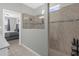 Bright bathroom featuring a glass shower with tile surround and neutral color palette at 3318 Current Ave, Winter Garden, FL 34787