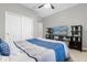 A bedroom with a ceiling fan, and a tv with a beach scene on a stand with shelves at 3318 Current Ave, Winter Garden, FL 34787