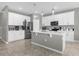 Modern kitchen with white cabinetry, stainless steel appliances, and a center island for food preparation at 3318 Current Ave, Winter Garden, FL 34787