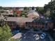 Aerial view of condo complex featuring mature trees and a glimpse of the water at 750 E Michigan St # 163, Orlando, FL 32806