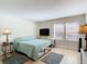 A lovely bedroom features hardwood floors, comfortable furnishings, and a bright, inviting atmosphere at 750 E Michigan St # 163, Orlando, FL 32806