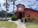 Image of the Community Cantina next to the pool, framed by swaying palm trees at 750 E Michigan St # 163, Orlando, FL 32806