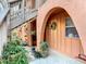 Inviting entryway featuring an arched doorway and lush landscaping at 750 E Michigan St # 163, Orlando, FL 32806