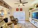 This cozy living room features two comfy recliners, a ceiling fan, and a decorative rug on the light wood floor at 750 E Michigan St # 163, Orlando, FL 32806