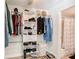 Well-organized walk-in closet with shelves, hanging rods, and a view of the adjacent bathroom at 750 E Michigan St # 163, Orlando, FL 32806