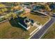 An aerial view of a well manicured property featuring a home with a two-car garage at 839 Waterfern Trail Dr, Auburndale, FL 33823