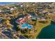 Aerial view of a community pool, clubhouse, tennis courts, and water feature at 839 Waterfern Trail Dr, Auburndale, FL 33823