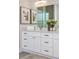 Bright bathroom features white cabinets, granite counters, and modern decor at 839 Waterfern Trail Dr, Auburndale, FL 33823