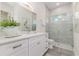 Contemporary bathroom with white cabinets, granite counters, and tiled shower at 839 Waterfern Trail Dr, Auburndale, FL 33823