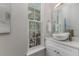 Bathroom features a vessel sink, granite counters, and decorative mirror at 839 Waterfern Trail Dr, Auburndale, FL 33823
