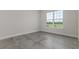 Empty bedroom showcases tile floors and large windows overlooking green space at 839 Waterfern Trail Dr, Auburndale, FL 33823