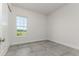 Bright bedroom features tile floors, a window, and white trim and door at 839 Waterfern Trail Dr, Auburndale, FL 33823