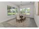 Bright dining area with ample windows, comfortable seating, and modern chandelier at 839 Waterfern Trail Dr, Auburndale, FL 33823