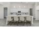 Spacious kitchen island with bar stool seating, modern appliances, and stylish pendant lighting at 839 Waterfern Trail Dr, Auburndale, FL 33823