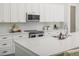 Bright kitchen boasts white cabinets, stylish countertops, and stainless steel appliances at 839 Waterfern Trail Dr, Auburndale, FL 33823