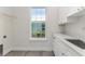 Bright laundry room with ample counter space, sink, and window for natural light at 839 Waterfern Trail Dr, Auburndale, FL 33823