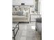 Bright living room features a gray accent rug, comfortable seating, and a view of the kitchen at 839 Waterfern Trail Dr, Auburndale, FL 33823