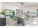 Open-concept living room featuring tile floors and sliding glass doors to backyard at 839 Waterfern Trail Dr, Auburndale, FL 33823