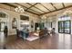 A community lobby showcases a coffered ceiling, chandeliers, and a large television over comfortable seating on a patterned rug at 839 Waterfern Trail Dr, Auburndale, FL 33823