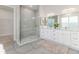 Beautiful bathroom featuring dual sinks, a glass shower, and neutral color palettes at 839 Waterfern Trail Dr, Auburndale, FL 33823