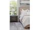 King bed with decorative wall art and a nightstand with a lamp at 839 Waterfern Trail Dr, Auburndale, FL 33823