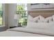 King bed with decorative wall art, a nightstand, and outside view at 839 Waterfern Trail Dr, Auburndale, FL 33823