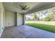 The screened patio has tile flooring, a ceiling fan, and views of the backyard at 839 Waterfern Trail Dr, Auburndale, FL 33823