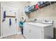 Convenient laundry room with washer, dryer, and storage shelves at 1429 Milledge Ln # 1429, Davenport, FL 33896