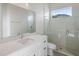 Bathroom features a walk-in shower, white vanity, and modern fixtures at 208 Snowy Orchid Way, Lake Alfred, FL 33850