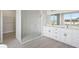Modern bathroom with double vanity, large shower, and white cabinets at 208 Snowy Orchid Way, Lake Alfred, FL 33850