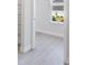 Light and airy bedroom with white walls and light grey wood-look flooring at 208 Snowy Orchid Way, Lake Alfred, FL 33850