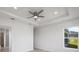 Bright bedroom with ceiling fan and window overlooking backyard at 208 Snowy Orchid Way, Lake Alfred, FL 33850
