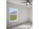 Bright bedroom with large window, neutral walls, and wood-look floors at 208 Snowy Orchid Way, Lake Alfred, FL 33850