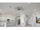 Modern kitchen with white cabinets, large island, and ceiling fan at 208 Snowy Orchid Way, Lake Alfred, FL 33850