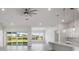 Spacious living area with high ceilings, hardwood floors, and view to backyard at 208 Snowy Orchid Way, Lake Alfred, FL 33850