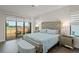 Bedroom with large windows that provide outdoor views, a mirrored headboard, and modern furniture at 15820 Vetta Dr, Montverde, FL 34756