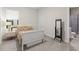 Bright bedroom features a bed with patterned bedding and a view of the en-suite bathroom at 15820 Vetta Dr, Montverde, FL 34756