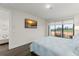 Bedroom featuring a TV, large windows with a view, and an en-suite bathroom at 15820 Vetta Dr, Montverde, FL 34756