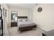 Cozy bedroom with carpeted floor, neutral walls, a minimalist wooden bed frame, and simple decor at 15820 Vetta Dr, Montverde, FL 34756