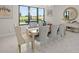 Dining room with a modern table, stylish chairs, contemporary decor, and a large window view at 15820 Vetta Dr, Montverde, FL 34756