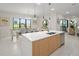 Bright kitchen with white countertop island and breakfast nook and view to the backyard golf course at 15820 Vetta Dr, Montverde, FL 34756