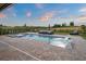 Serene backyard swimming pool and tanning ledge, with a beautiful view of the green golf course at 15820 Vetta Dr, Montverde, FL 34756