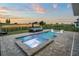 Beautiful outdoor swimming pool with jacuzzi and luxurious outdoor seating area overlooking the golf course at 15820 Vetta Dr, Montverde, FL 34756