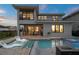 Outdoor patio with swimming pool, hot tub and outdoor furniture, with the home's rear elevation in view at 15820 Vetta Dr, Montverde, FL 34756