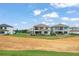 Rear view of multiple homes showing back patios and swimming pools with a view of the landscape at 15820 Vetta Dr, Montverde, FL 34756