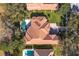 Bird's eye view of a home with a distinctive tile roof and a large pool at 6130 Blakeford Dr, Windermere, FL 34786