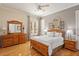 Bedroom with wood furniture and large window at 6130 Blakeford Dr, Windermere, FL 34786
